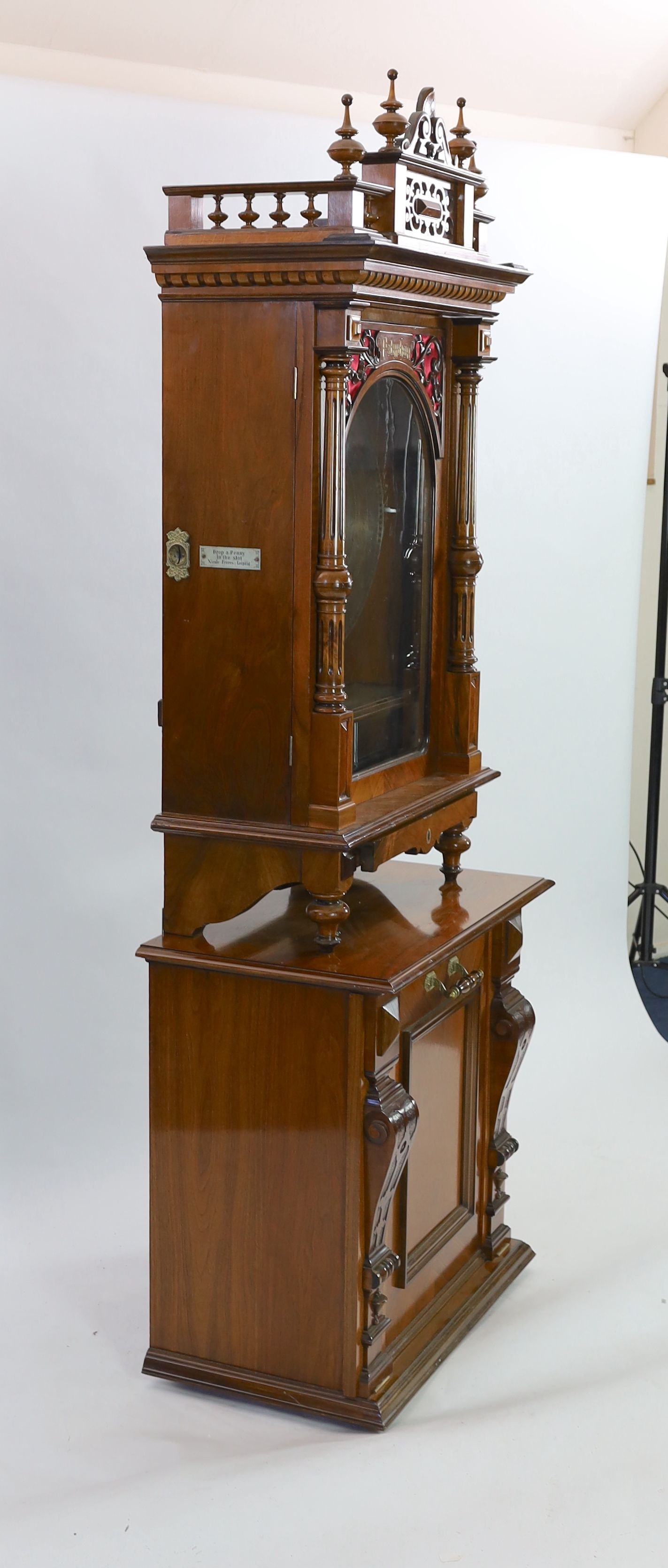 A 19th century oak and walnut cased coin operated Polyphon disc music player retailed by Nicole Freres Leipzig, the double vertical steel comb playing 24.5 inch discs, the carved column floor standing case with pierced p